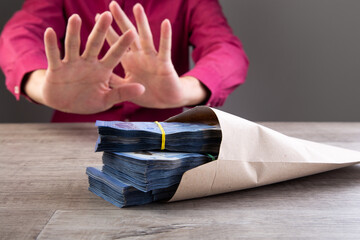 Businessman refusing money in the envelope