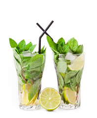 Cocktail mojito with mint leaves, lime and ice isolated on a white background.