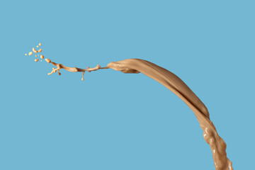 Photo of coffee or brwon liquid splash with drops isolated on black background. Close up view