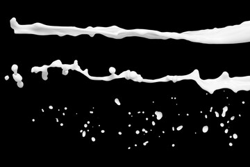 Photo of milk or white liquid splash with drops isolated on black background. Close up view