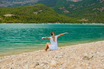 Fototapeta na wymiar girl on the shore of a beautiful lake