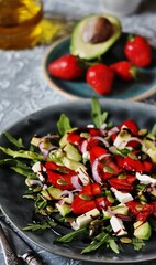 strawberries salad and avocado, arugula, feta cheese, pumpkin seeds, red onion. dressed with balsamic sauce