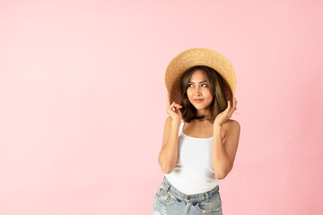 Asian women tourists wear summer clothes. Isolated on pink background