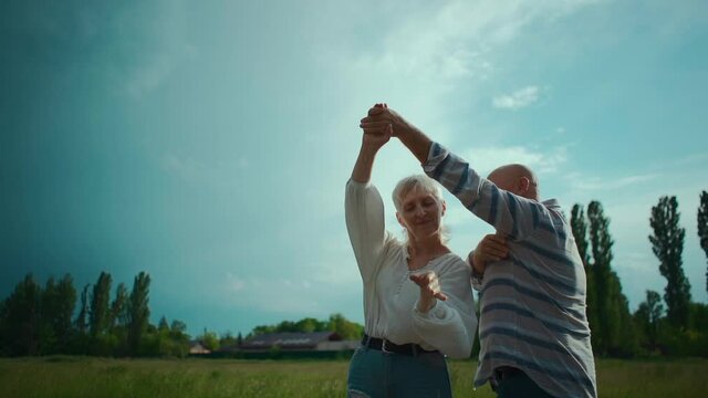 happy senior couple have romantic dating and dancing outdoor at sunset