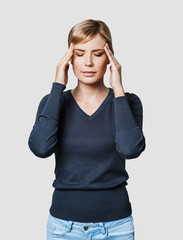 Young beautiful woman has headache isolated studio portrait