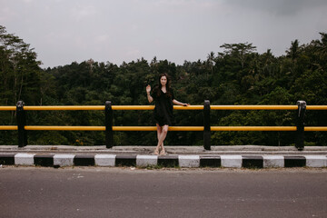 woman in dress on a bridge in Asia