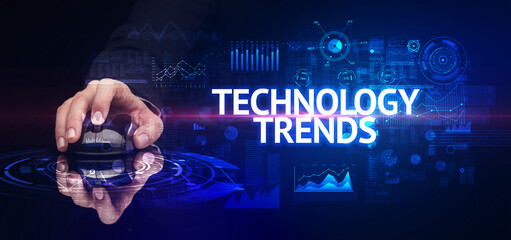hand holding wireless peripheral with TECHNOLOGY TRENDS inscription, modern technology concept