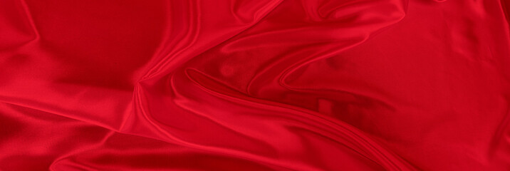 Black red satin dark fabric texture luxurious shiny that is abstract silk cloth background with patterns soft waves blur beautiful.