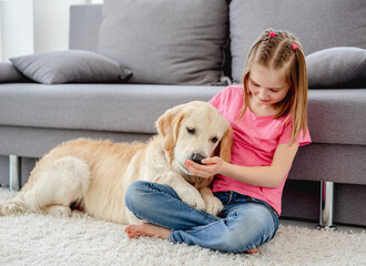 Girl playing with dog at home