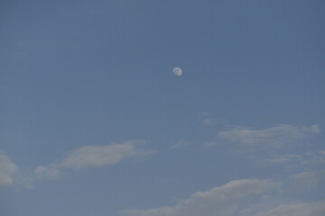 Moon and cloud on blue sky.