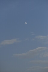 Moon and cloud on blue sky.