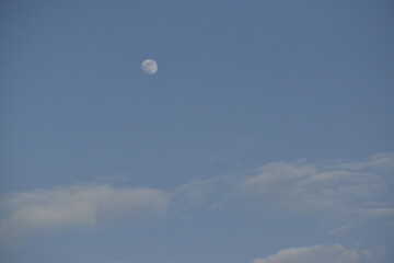 Moon and cloud on blue sky.