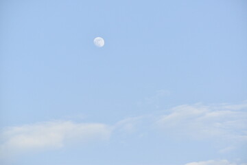 Moon and cloud on blue sky.