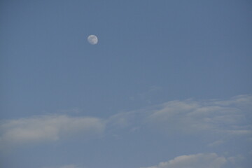 Moon and cloud on blue sky.