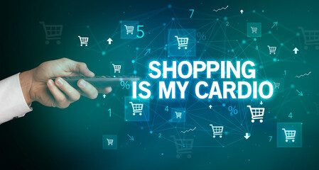 hand holding wireless peripheral with SHOPPING IS MY CARDIO inscription, online shopping concept