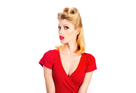 Pin up woman portrait. Beautiful retro female with red lips and old fashion hairstyle. Caucasian blond model posing in retro fashion and vintage concept studio shoot.