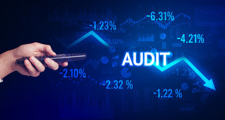 male hand holding wireless peripheral with AUDIT inscription, modern business concept