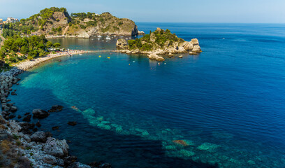 Fototapeta na wymiar A view of the shoreline and Isola Bella near Taormina, Sicily in summer