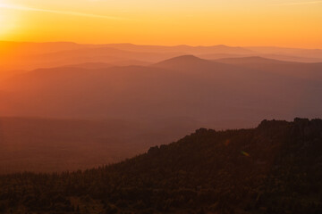 Obraz premium warm golden sunset over pink hills
