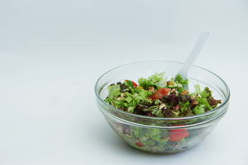 summer salad with fresh vegetables in a large glass plate
