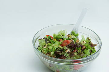 summer salad with fresh vegetables in a large glass plate