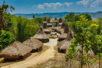 Fototapeta na wymiar Sumbanese traditional homes and megalithic tombs. Sumbanese uma mbatangu, refers to the traditional house of the Sumba people in Indonesia. Location is near the village of Waitabula.