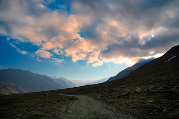 Himalayan valley landscape with road near Kunzum La pass, Spiti Valley, India.