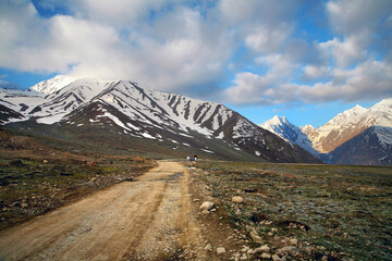 Himalayan valley landscape with road near Kunzum La pass, Spiti Valley, India.