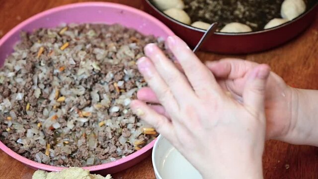 Woman hands making and preparing middle eastern traditional food. Delicious Kibbeh, famous in Arabic country especially in  Lebanon, Syria.