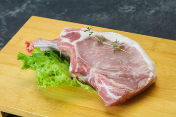 Raw pork bone steak over wooden