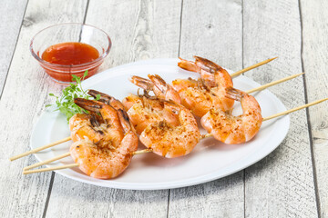 Grilled prawn skewer with sauce