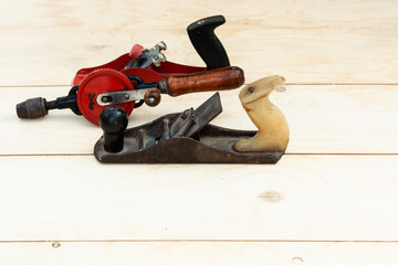 Joinery – old wooden plane, wood polishing tool in a workshop of the carpenter, retro concept.