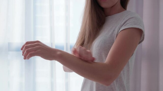 Young woman suffering from itching on her skin and scratching an itchy place. Allergic reaction to insect bites, dermatitis, food and medicine. Allergy rash