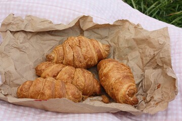 Delicious fresh croissants on a picnic macro