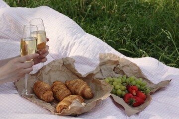 Croissants fruit and champagne on a picnic