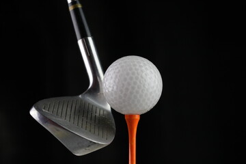 Photo of a golf iron club behind the ball on the fairway