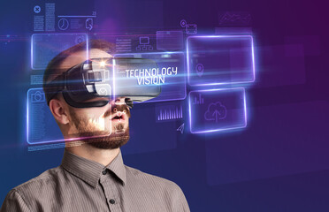 Businessman looking through Virtual Reality glasses with TECHNOLOGY VISION inscription, new technology concept