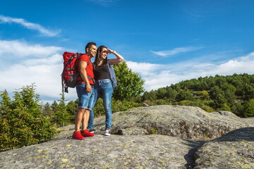 Hiker couple on the mountain looking at the horizon