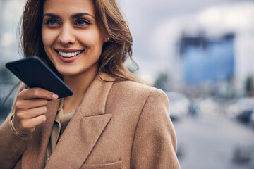 Beautiful businesswoman talking on the phone outdoors