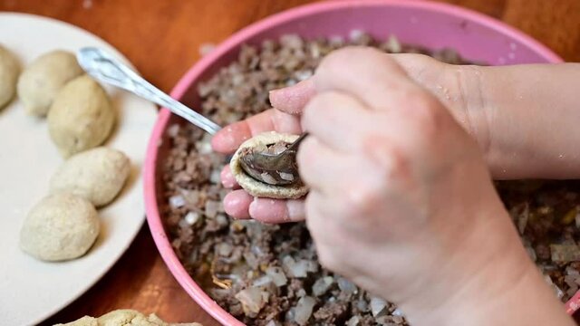 Woman hands making and preparing middle eastern traditional food. Delicious Kibbeh, famous in Arabic country especially in  Lebanon, Syria.