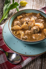 Meatballs in gravy with cast noodles.