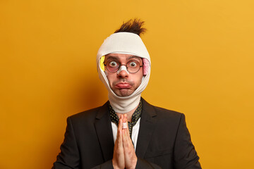 Photo of discontent young man with swollen bruised face, recovers after serious injury asks God for...