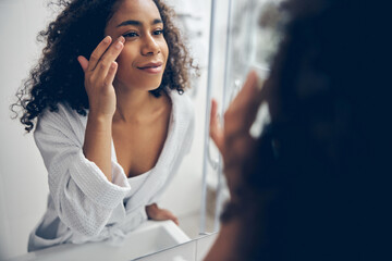 Beautiful woman staring at herself in the mirror
