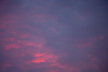 crimson clouds in the sky in the evening at sunset