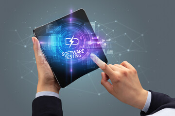 Businessman holding a foldable smartphone with SCIENCE inscription, new technology concept SOFTWARE TESTING