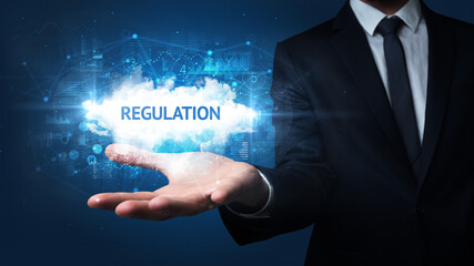 Hand of Businessman holding REGULATION inscription, successful business concept