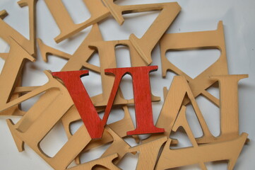 Wooden red roman numeral six on a white background