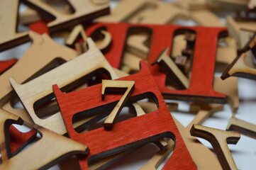 Wooden red roman numeral seven on a white background