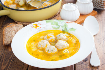 Potato soup with meatballs on a wooden table, horizontal