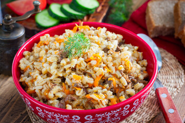 Barley porridge with stewed beef in a ceramic bowl, selective focus